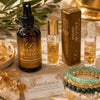 Infinite Abundance spray, roll-ons, bracelets, and citrine crystals displayed on linen.