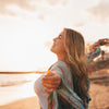 Happy woman facing the ocean