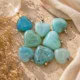 Turquoise heart-shaped beads on a beige fabric background