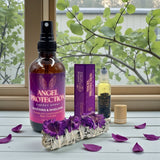 Angel Protection energy spray and other products on a windowsill with purple flowers.