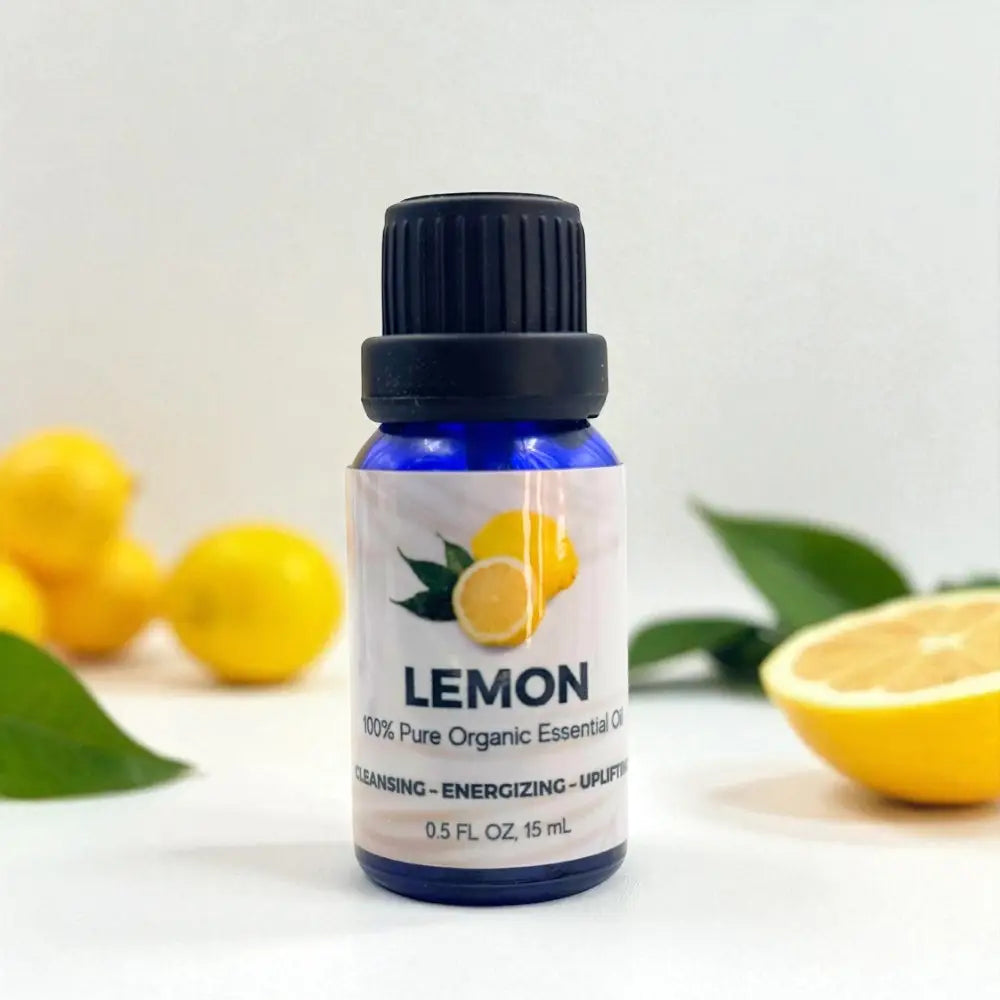 Bottle of lemon essential oil with lemons and leaves on a light background