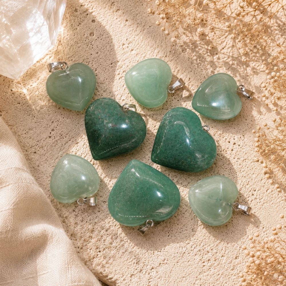 Green Aventurine Mini Heart Pendants on a warm limestone surface with soft linen and dried florals in natural sunlight.