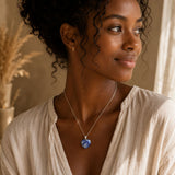 Woman wearing a Sodalite heart pendant necklace with a casual neutral outfit.