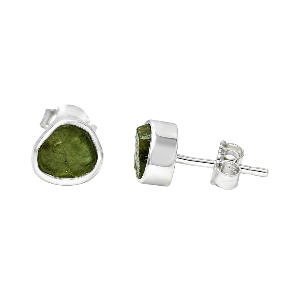 A pair of sterling silver stud earrings featuring rough Moldavite shown on a plain white background with one earring facing forward and the other showing the side profile and post backing.