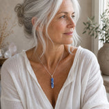 Person wearing a Sodalite crystal point pendant on a simple silver chain.