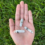 Woman wearing a Tourmalinated Quartz crystal point pendant on a simple silver chain.