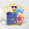 Sacred Geometry of Relationships Oracle cards on a light background with flowers.