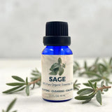 Bottle of Sage essential oil with a label on a light background