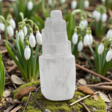 Selenite tower on a natural background with snowdrops