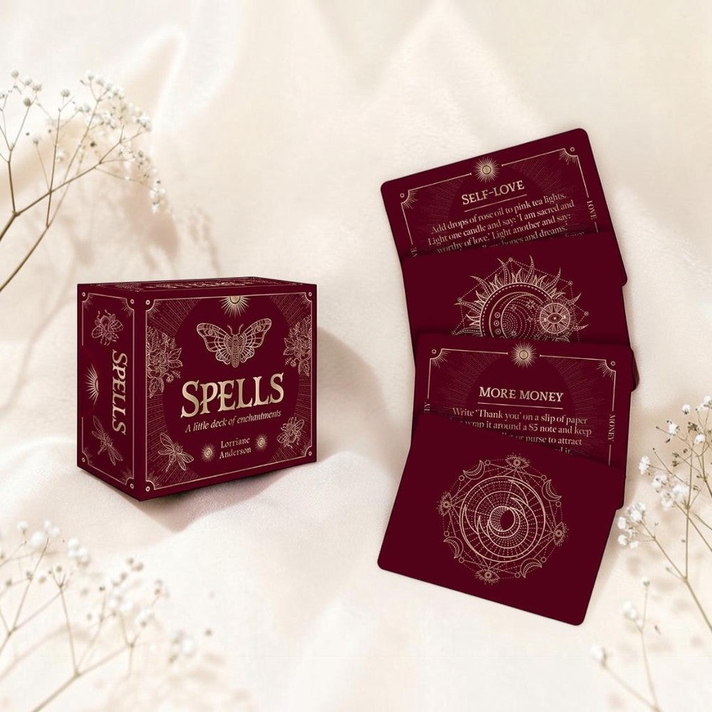Red card deck with 'Spells' packaging on a soft beige background