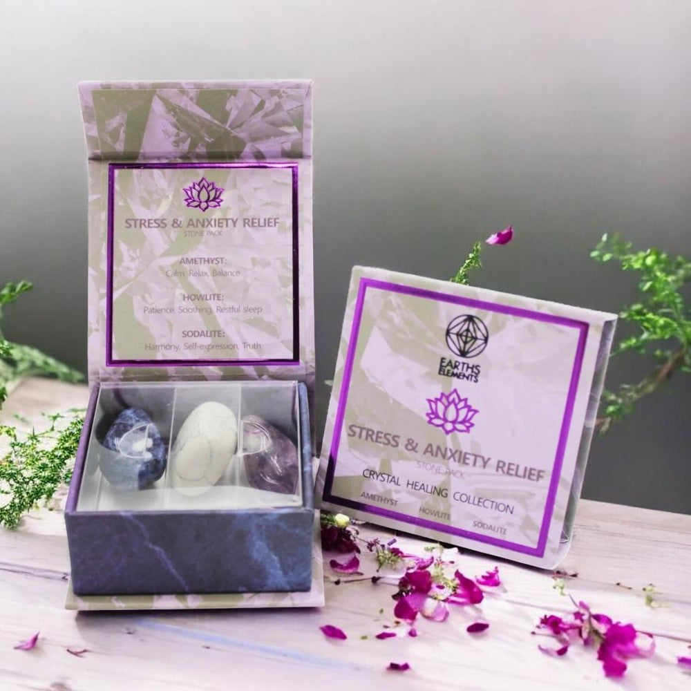 Stress and anxiety relief crystal set with packaging on a wooden surface with flowers.