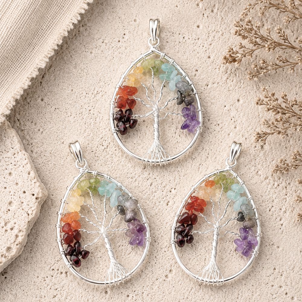 Three Tree of Life pendants featuring silver wire trees with colorful natural gemstone chips on a textured stone background.