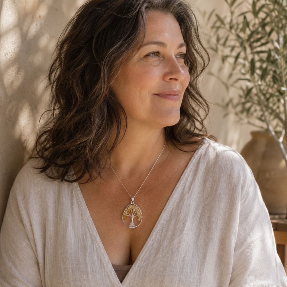 Woman wearing a Citrine Tree of Life pendant with natural citrine gemstone chips and a silver wire tree design on a delicate necklace. 🌿