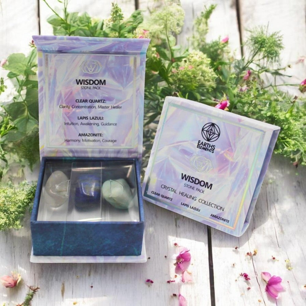 Crystal stone pack with packaging labeled 'Wisdom' on a wooden surface with plants in the background.