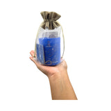 Hand holding a clear bag with a blue product and drawstring on a white background