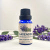 Bottle of lavender essential oil with lavender flowers on a white background