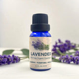 Bottle of lavender essential oil with lavender flowers on a white background