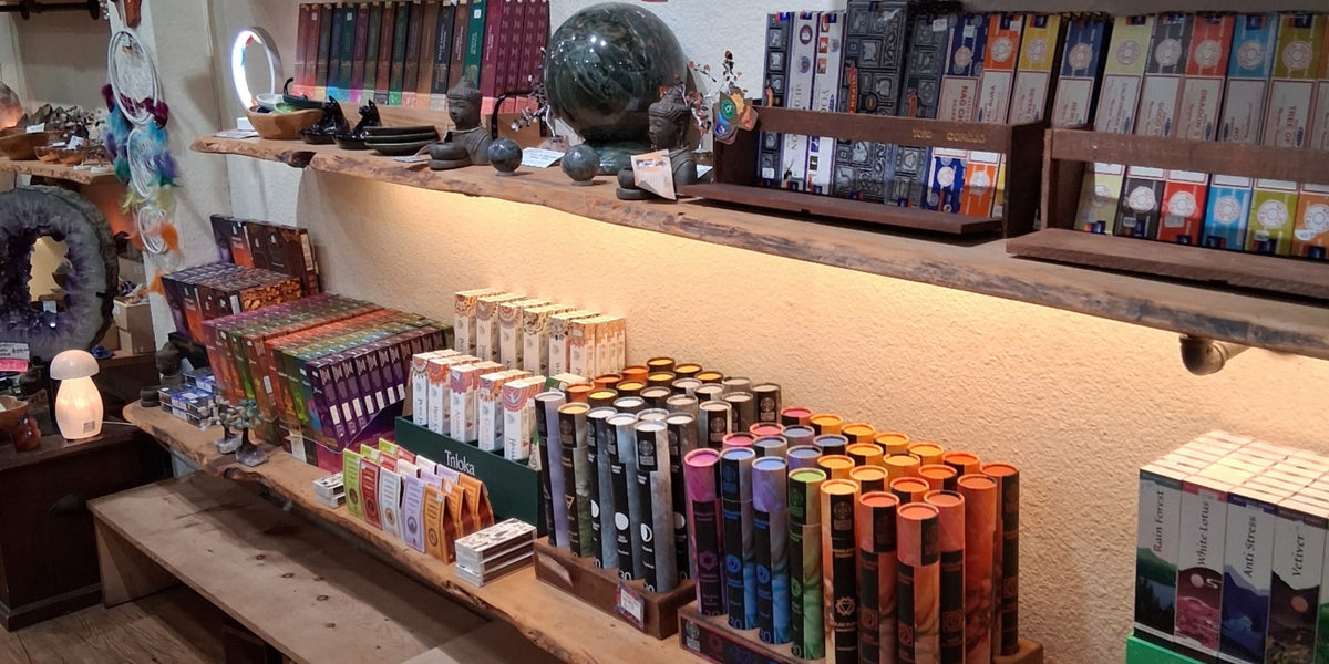 Display of incense items in a store with a counter and shelves.