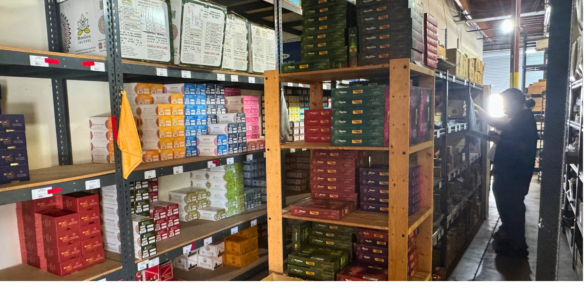 Person inspecting shelves filled with boxes in a warehouse setting