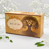 A box of Himalayan Tree of Life incense sticks, featuring a golden-brown design with an illustration of a tree of life and white flowers arranged around it on a white surface.