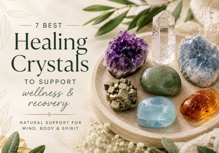 Healing crystals including Amethyst, Clear Quartz, Amber, Jade, Aquamarine and Pyrite arranged on a natural stone tray.