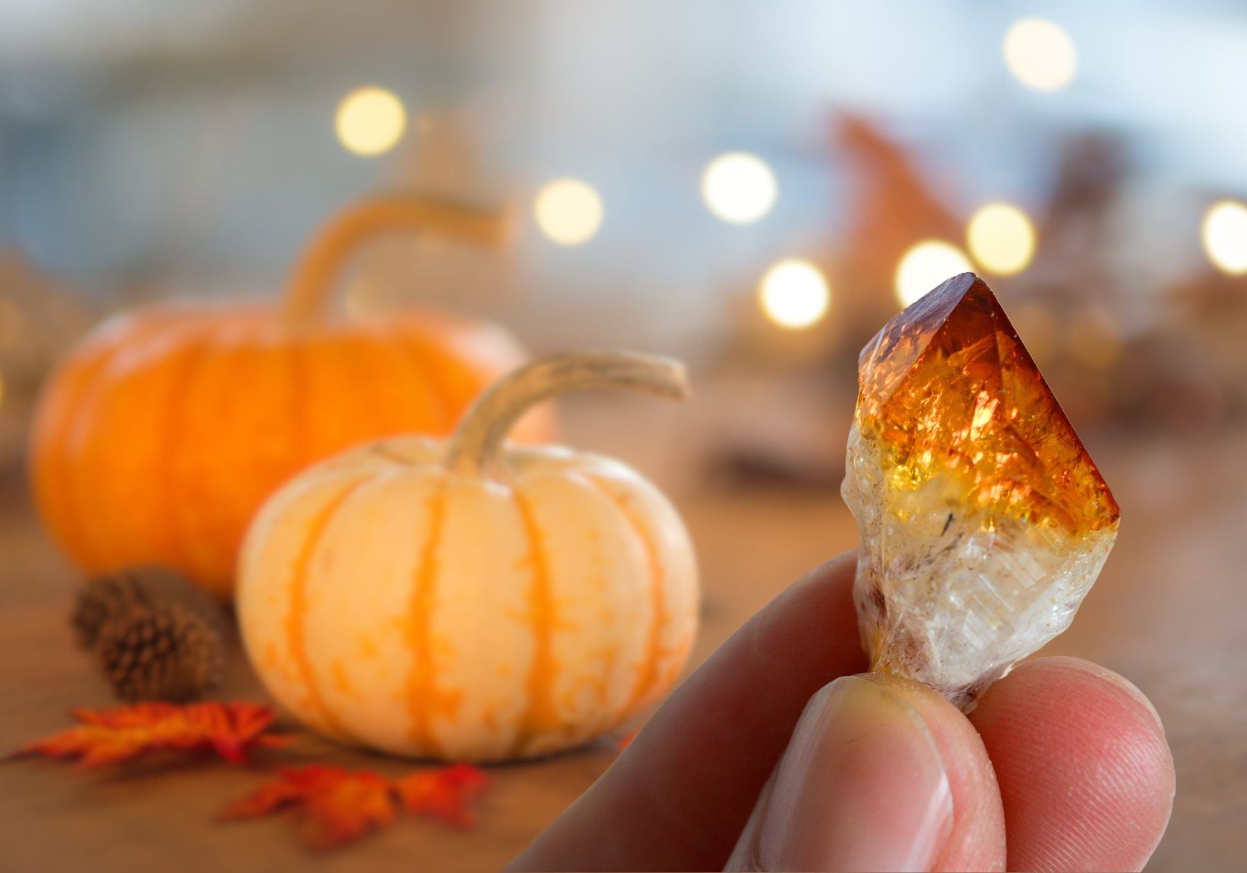 pice of shining citrine with pumpkins in the background