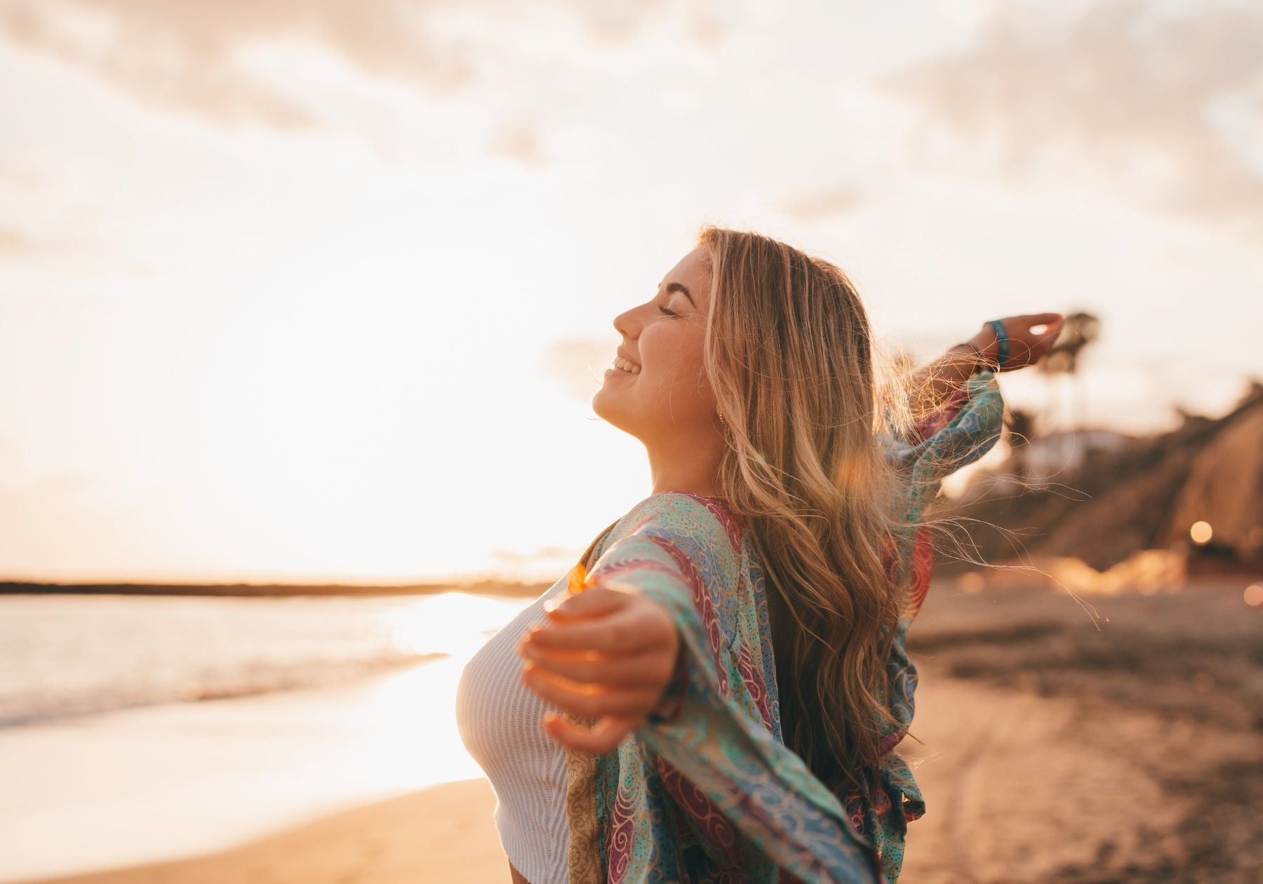 Happy woman facing the ocean