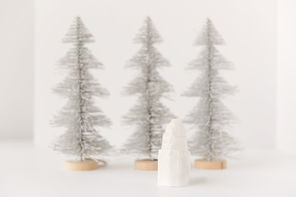 small selenite tower with silver Christmas trees in the back