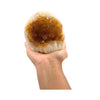Hand holding a large crystal geode against a white background