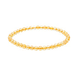 A beaded stretch bracelet made of Citrine beads with a warm yellow-gold internal tint, shown on a plain white background.