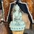 white buddha statue with a large citrine butterfly geode in the background