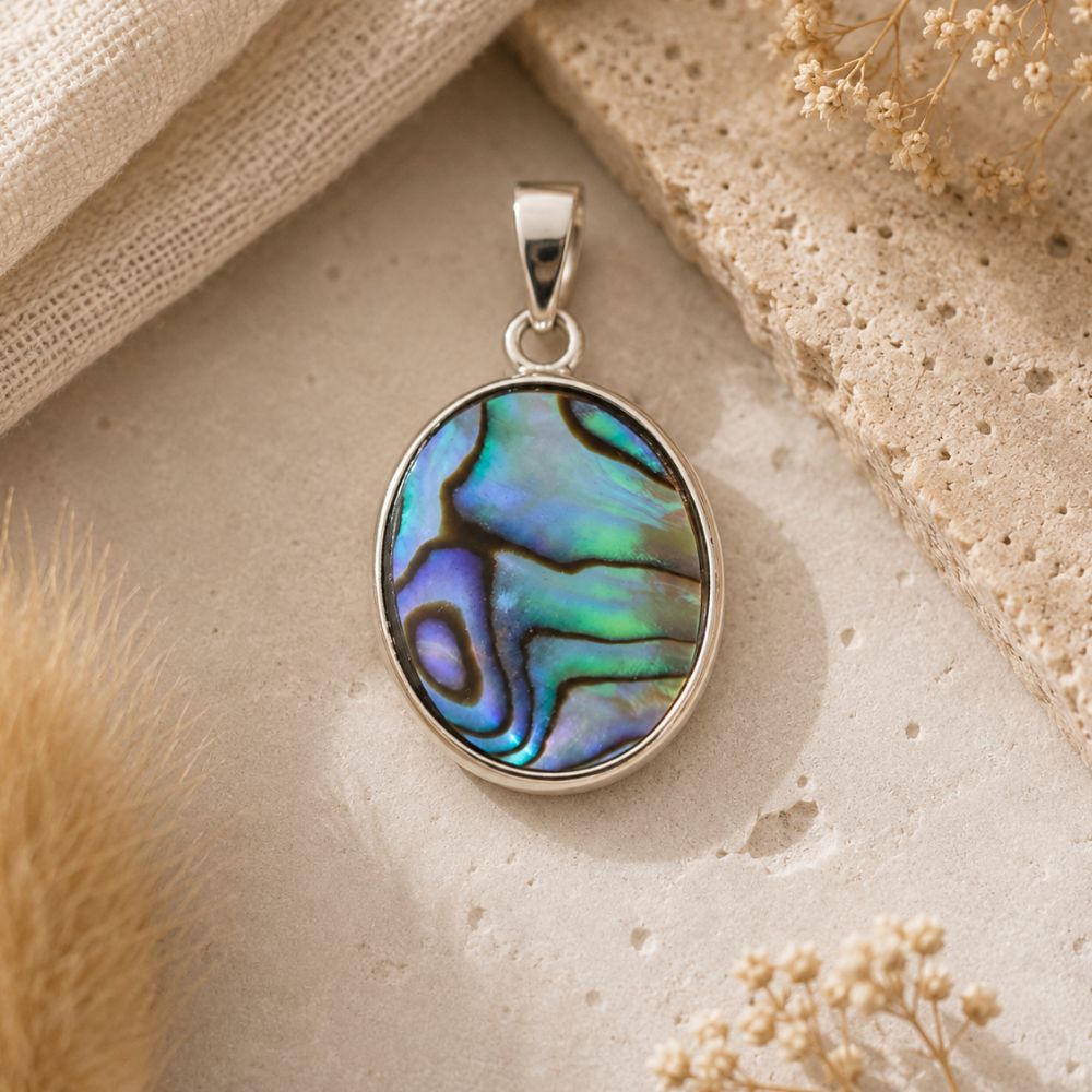 Abalone Shell Oval Pendant with iridescent abalone shell in a polished silver oval setting.