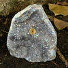 necklace displayed on aura quartz geode