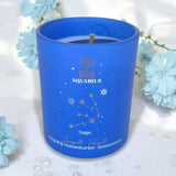 Blue candle with Aquarius design on a white background with light blue flowers.