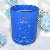 Blue candle with Aquarius design on a white background with light blue flowers.