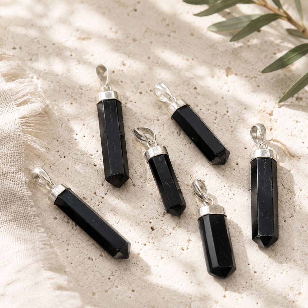 Black Tourmaline point pendant with a silver cap and bail.
