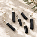 Black Tourmaline point pendant with a silver cap and bail.