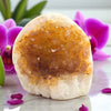Geode crystal with a pink orchid in the background