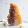 Citrine rock with brown crystals on a white background
