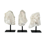 Clear Quartz Cluster on stands against a white background