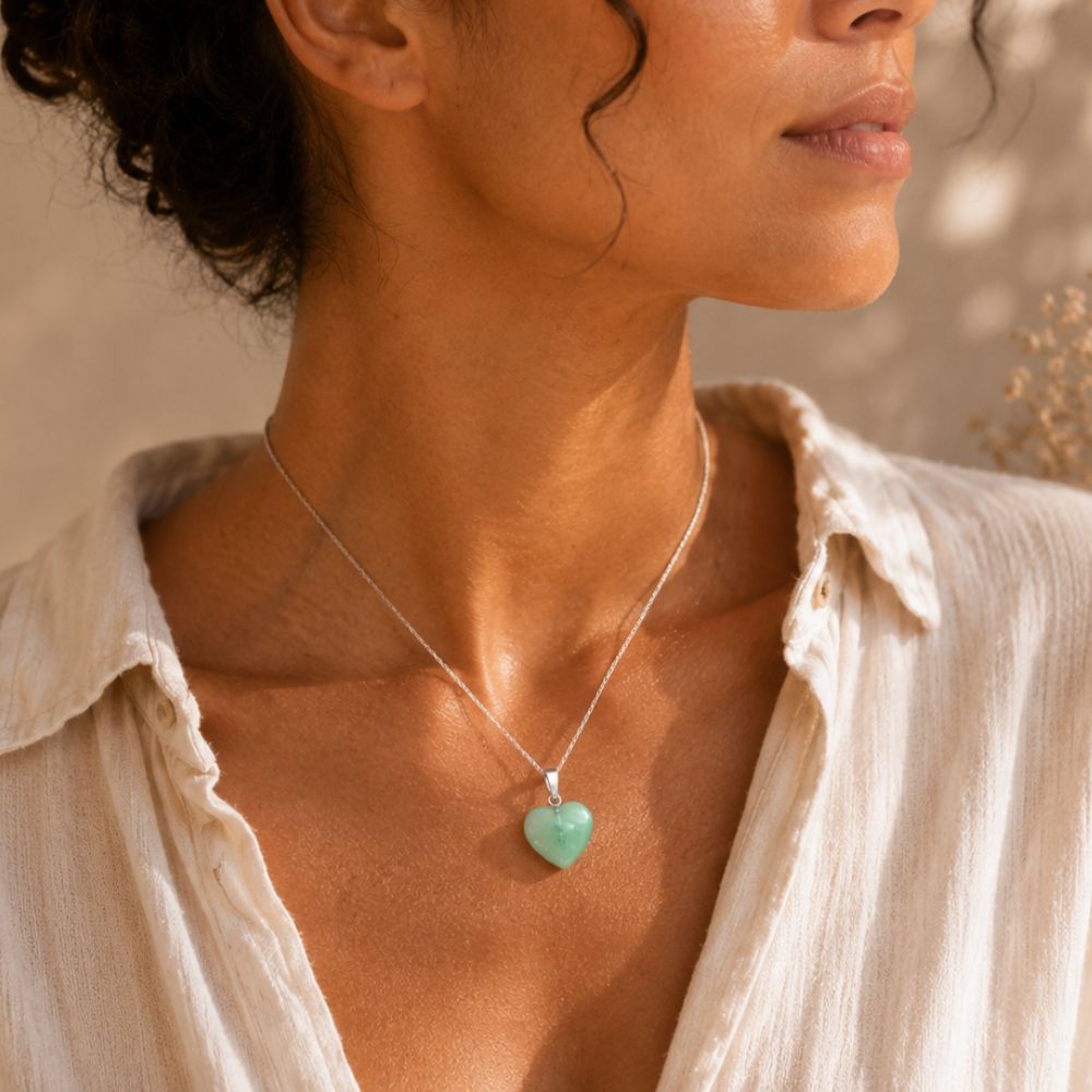 Woman wearing a Fluorite Mini Heart Pendant necklace in warm natural sunlight.