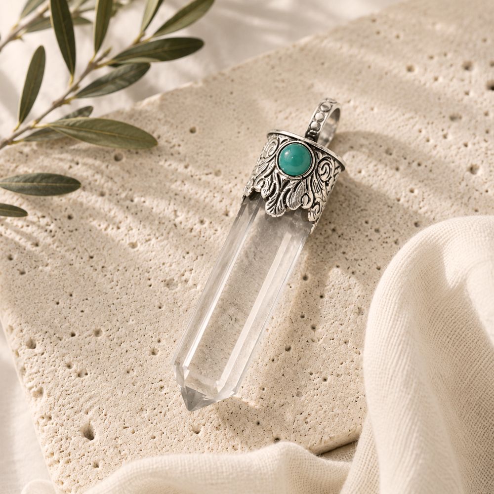 Clear Quartz Point Pendant with Turquoise featuring a faceted clear quartz crystal, ornate silver cap, and turquoise accent.