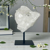 Clear Quartz Cluster on Stand with a blurred background