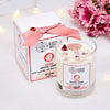 Crystal candle with packaging and flowers on a white background