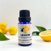Bottle of lemon essential oil with lemons and leaves on a light background