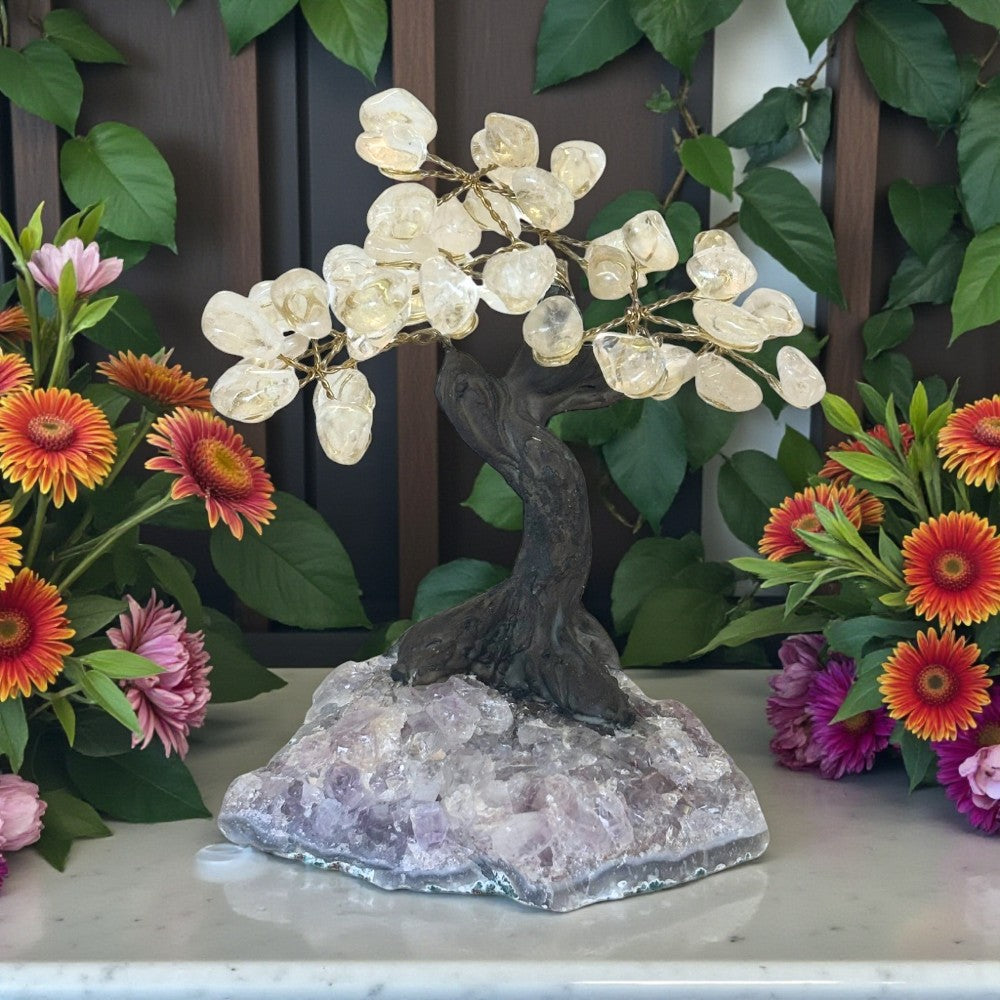 Decorative tree lamp on a crystal base with flowers in the background