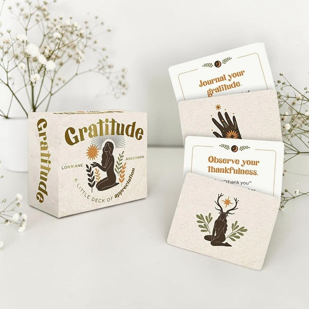 Gratitude card set with cards and packaging on a light surface with flowers in the background