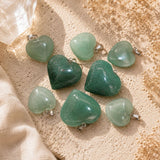 Green Aventurine Mini Heart Pendants on a warm limestone surface with soft linen and dried florals in natural sunlight.