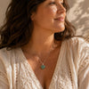 Woman wearing a Green Aventurine Mini Heart Pendant necklace in warm natural sunlight.