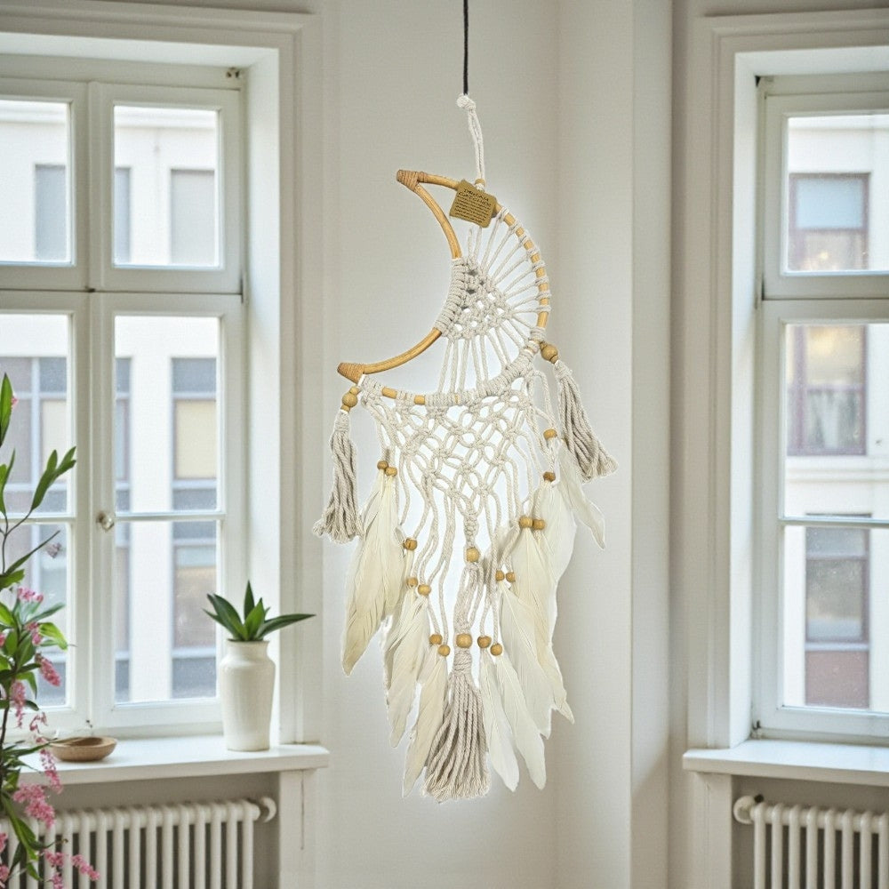 Decorative dreamcatcher hanging in a room with windows and a radiator.